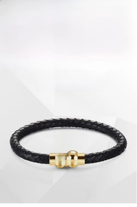 Detail of black woven leather bracelet with gold titanium steel magnetic clasp
