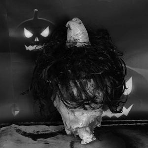 Realistic Halloween severed head prop with black hair for haunted house decor