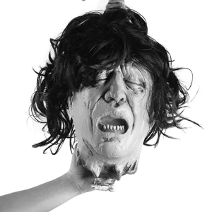 Realistic severed head prop with black hair and gory neck details for Halloween haunts