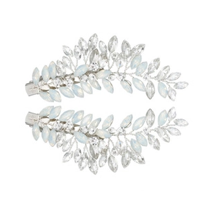 Detailed close-up of two silver leaf-shaped hair clips with crystals on a white background