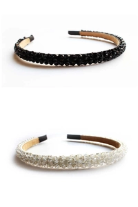 Detail view of crystal-encrusted headbands in black and transparent tones for women