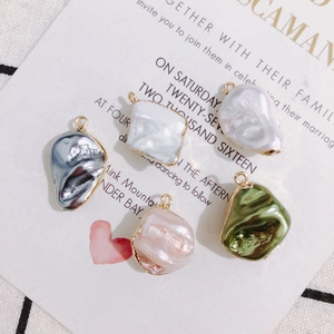 Five baroque style irregular pearl pendants with gold edges on vintage cards