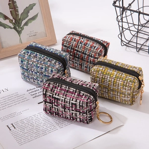 Colorful plaid tweed stationery pouches with gold keychains and secure black zippers