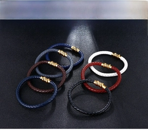 Close-up of multi-color woven leather bracelets for men with gold metal clasps