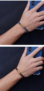 Detail of woven leather bracelets with magnetic gold clasps in blue and brown