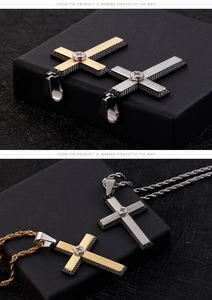 Macro detail of two-tone stainless steel cross pendant with striped industrial texture