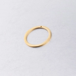 Close-up of a 30mm golden polished stainless steel circle pendant with a small hole