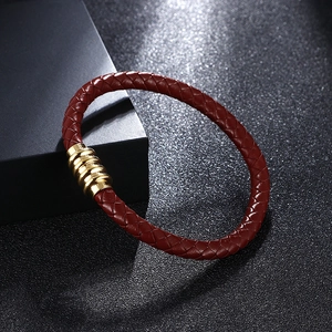 Deep red woven leather bracelet with gold magnetic clasp on premium black box