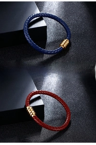 Macro detail of braided leather bracelets in blue and red with magnetic metal clasps