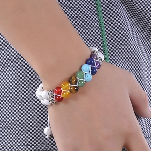 Detail of adjustable white turquoise chakra beaded bracelet on person wrist