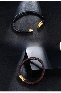 Detail of woven leather bracelets with gold magnetic clasps in black and brown colors
