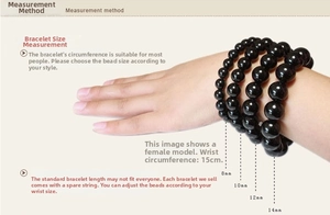 Size chart for black cylinder beads showing 8mm to 14mm diameters on a 15cm wrist