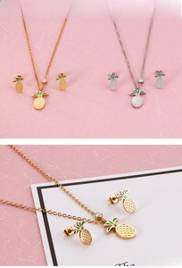 Detail view of cute pineapple necklace and earrings set with green leaf accents
