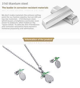 Detail of 316L titanium steel pineapple jewelry set with green enamel and zircons