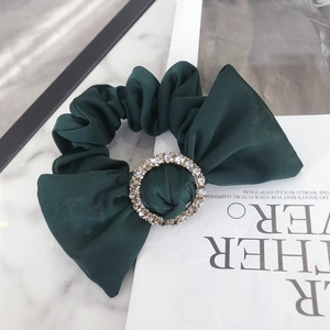 Elegant dark green satin scrunchie with a large bow and a sparkling crystal center