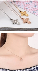 Detailed view of cross pendant necklaces in silver, rose gold, and gold finishes