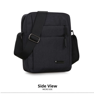 Detailed side view of black oxford fabric shoulder bag showing smooth zippers and strap