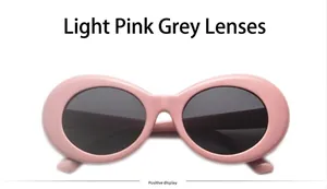 Macro detail of retro oval pink sunglasses with protective dark grey UV lenses