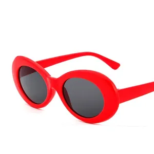Fashionable red oval frame sunglasses with dark lenses for a retro pop art style look