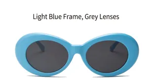 Detail view of oval light blue sunglasses frame with dark grey lenses for fashion