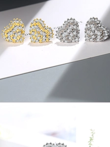 Macro shot of heart-shaped earrings with micro-pave cubic zirconia in gold and silver
