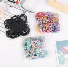 Detailed view of elastic rubber hair bands in black and colorful sets for children