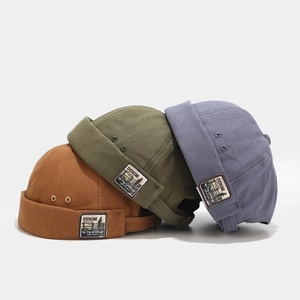 Retro canvas docker hats in caramel, green and blue with adjustable strap and side label