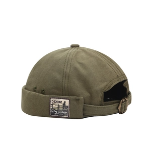 Vintage olive green canvas docker cap with adjustable metal buckle and retro woven patch
