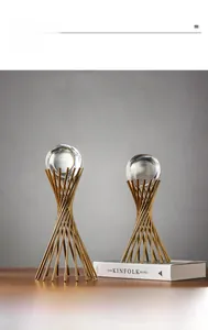 Close-up of modern gold spiral crystal ball stand for minimalist luxury home decor
