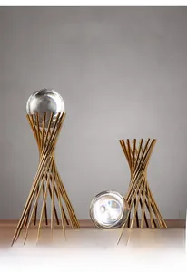 Detail view of modern crystal ball ornaments with elegant gold metal twisted stands
