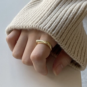 Minimalist 925 sterling silver cone ring with a polished gold finish on fingers