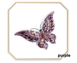 Macro shot of butterfly brooch featuring purple and AB crystals set in alloy base