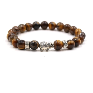 Detailed view of natural tiger eye beads with silver elephant charm and carved spacers