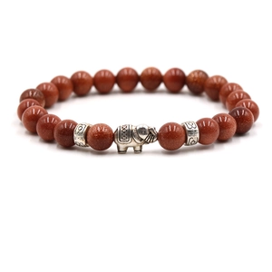 Detail of beaded bracelet with red goldstone beads and silver elephant charm