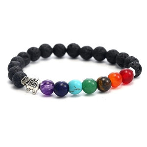 Macro shot of 7 chakra natural stones and lava beads with an elephant charm