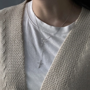Silver Y-shaped layered cross pendant necklace on model with a minimalist chic style
