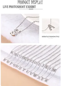 Close-up of sparkling silver alphabet pendants with white rhinestones on soft white fur