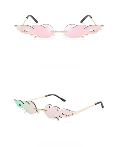 Detail of pink flame-shaped rimless sunglasses with gold metal temples for party