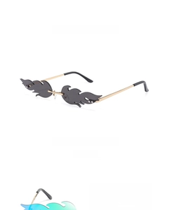 Close-up of rimless flame-shaped sunglasses with metal frames and decorative studs