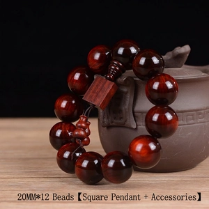 Macro shot of 20mm red sandalwood prayer beads with natural grain and square pendant