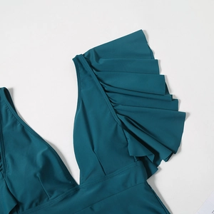 Detail of dark teal ruffled bikini top featuring deep V-neckline and layered frill design