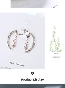 Macro detail of rose gold crescent moon and star earrings with pavé cubic zirconia