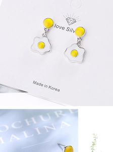 Detail showing cute poached egg studs on a silver card with close-up of the earring post