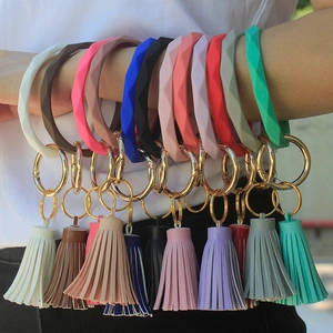 Close-up of geometric silicone wristlets with leather tassels in various vibrant colors