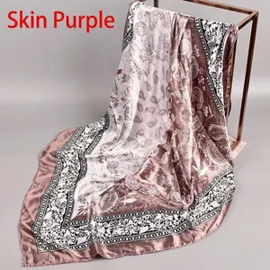 Close-up of mauve silk square scarf with paisley pattern and geometric border