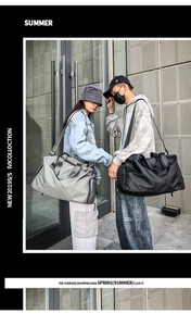 Outdoor shot of men and women carrying large nylon travel bags in gray and black colors