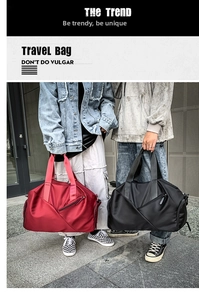 Detail view of red and black waterproof nylon gym bags with side zipper and sturdy handles