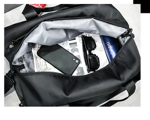 Top view of open travel duffel bag showing spacious interior with grey lining and accessories