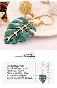 Detail of green monstera leaf keychain with gold frame and marble texture hanging parts