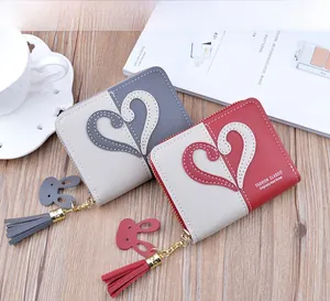 Detailed close-up of short patchwork purses with heart stitching and tassel charms